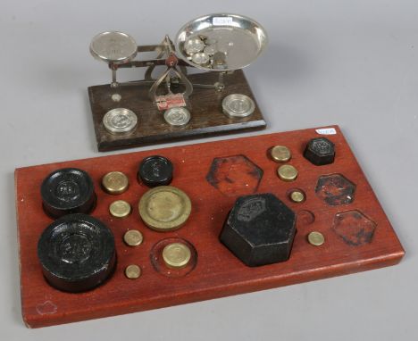 A Johnsons of Hendon Limited set of weighing scales and weights along with a quantity of brass and cast iron weights.