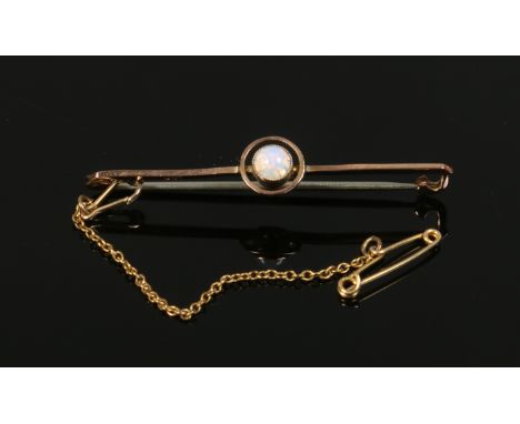 A 9ct gold bar brooch set with a cabachon cut opal, gross weight 1.9 grams.