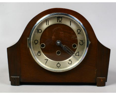 A vintage dome topped mahogany cased mantel clock housing a three train movement.