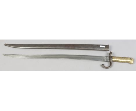 A French sword bayonet in metal scabbard and with brass grip.