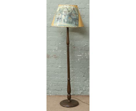 A turned hardwood standard lamp with novelty shade.