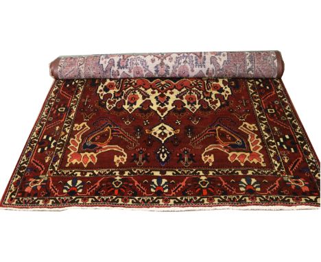 A hand woven Persian bakhtiari carpet with a traditional design, 210cm x 307cm