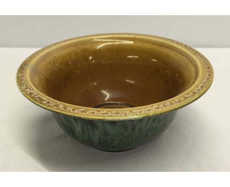A Holkham pottery green glazed bowl with light brown interior.