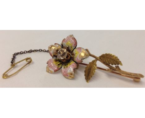 A vintage gold brooch of flower design set with a 0.5 carat diamond and enamel petals. Some damage to enamel and unhallmarked