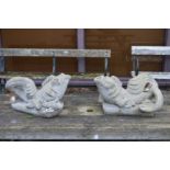 A pair of reconstituted stone dolphin water features.
