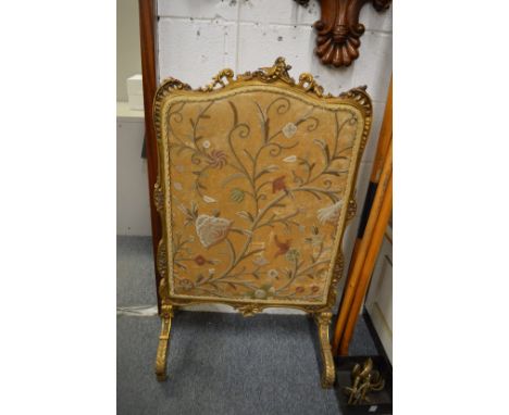 A gilt framed fire screen.
