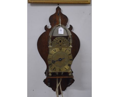 A good 18th century brass lantern clock on later wall bracket.