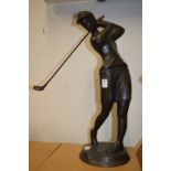 Bronze figure of a golfer.