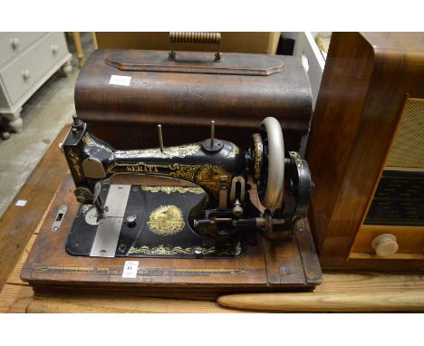 An old Serata sewing machine, a Bush radio, an old pitch fork and long handled window opener.