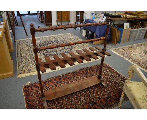 A Victorian mahogany hunting boot and whip rack.