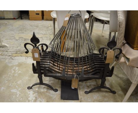 A cast iron fire grate with wrought iron fire dogs and another items.