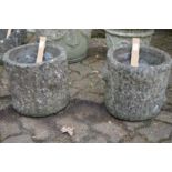 A pair of reconstituted stone planters.