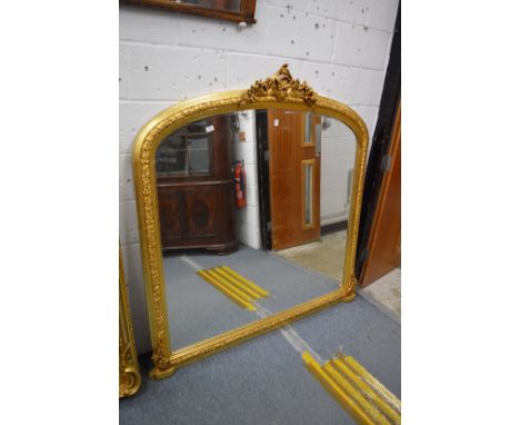 A large Victorian style gilt framed over-mantel mirror.