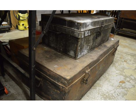 Two old steel trunks and another trunk.