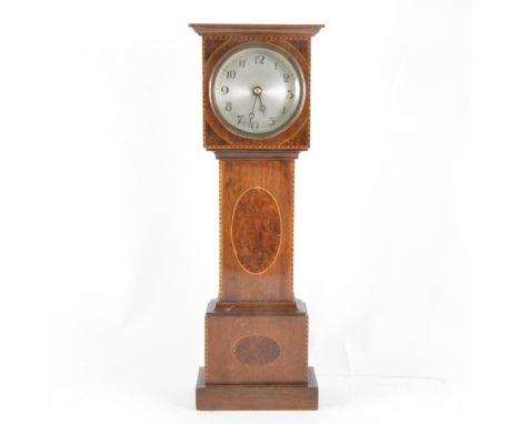 A novelty mantel clock, designed as a mahogany and yew wood longcase clock, with stringing, silvered dial, spring driven move