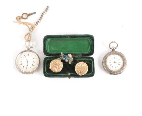 A white metal open face pocket watch, white 33mm dial with red roman numerals in gold gadrooned circles, light blue outer min