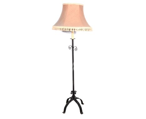 A wrought iron standard lamp, candle fitment, complete with shade, 163cm overall.