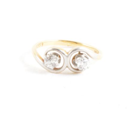 A diamond two stone ring, the old brilliant cut stones claw set in a yellow and white metal mount with the white metal should