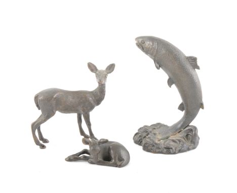 A bronze model of a leaping carp, 12cm; and two bronze animalias of a deer and fawn, (3).