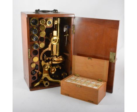 A lacquered brass binocular microscope, J. Swift &amp; Son, 81 Tottenham Court Road, London, 40cm; and a collection of lenses