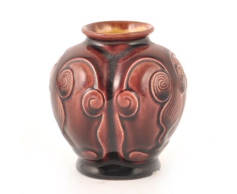 A small vase designed by Dr Christopher Dresser for Linthorpe Art Pottery, aubergine glaze, the lobed body modelled Oriental 