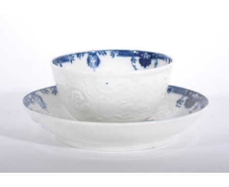 A Caughley blue and white moulded tea bowl and saucer, chrysanthemum head to centre, underglaze C to underside of both pieces