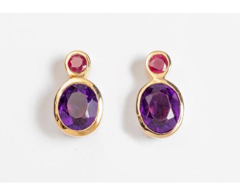 Each bezel set with an oval mixed-cut amethyst measuring approximately 8 x 6,5mm and a round mixed-cut ruby measuring approxi