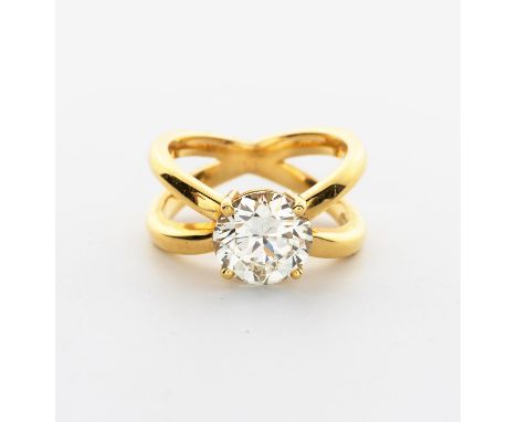 Designed as two crossed bands, claw set to the centre with a round brilliant-cut diamond weighing 2.65cts, in 18ct gold, sign