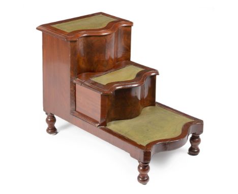 Each serpentine step with an inset gilt-tooled leather surface, the middle step with commode drawer, on turned legs82cm high,