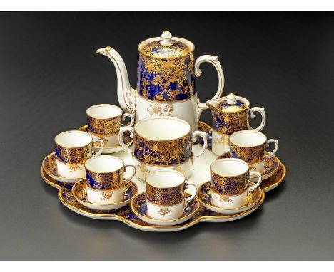 Comprising: a coffee pot, 6 duos, a creamer and cover, a two-handle sugar basin (cover lacking), all on a shaped serving tray