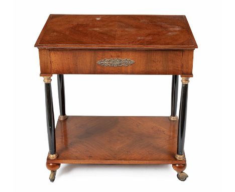 The quarter-veneered rectangular top above a frieze drawer, raised on ebonised and gilded turned columns, on ball feet joined