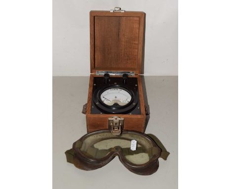Military issue Kilovolt meter dated 1954, set in a wooden case, together with a pair of rubber mounted Army goggles model KL5