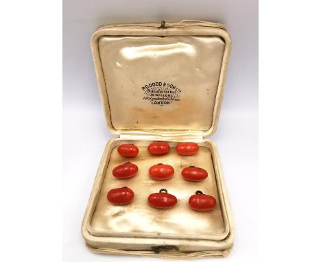 A collection of nine 19th century torpedo shaped orange coral and yellow metal (tested 9ct gold) waistcoat buttons. L.1.3cm 