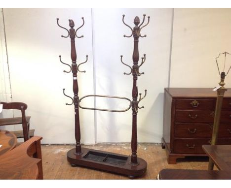 An unusual late Victorian mahogany double hall stand, the paired baluster-turned columns each with acorn finial and fitted wi