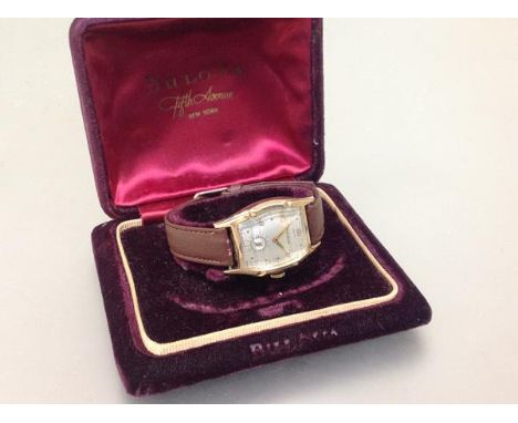 A vintage Bulova gentleman's 10k rolled gold wristwatch, c. 1950/60, the shaped cushion case enclosing a silvered dial with A