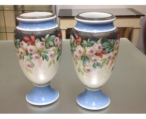 A pair of large Victorian painted opaque glass vases, of baluster form, each with white metal rim, the body painted with a fl