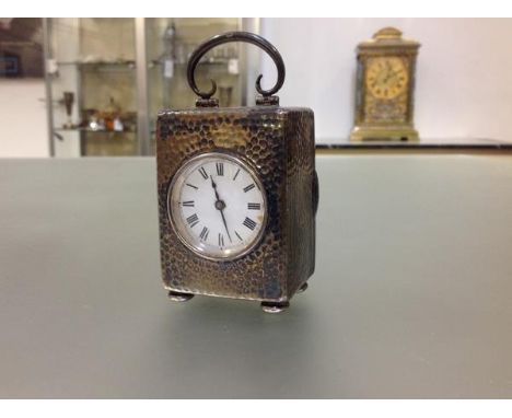An Edwardian silver travelling carriage clock of small proportions, the case hallmarked for London 1903, the planished case r