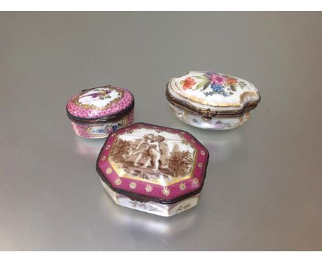 A group of three Continental porcelain table boxes, 19th century and later, the first of shaped oval form, painted with flora
