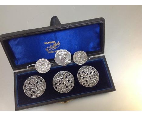 A cased set of three Edwardian silver lady's buttons, Birmingham 1901, each circular, pierced with c-scrolls and flowers; tog