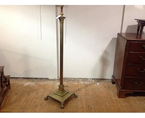A brass Corinthian columnar standard lamp, the fluted column raised on a stepped square base supported on paw feet. Height 12