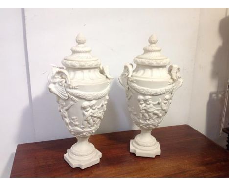 A pair of large composition urns in the Neoclassical taste, each stepped domed cover with berry finial, over a vasi-form body