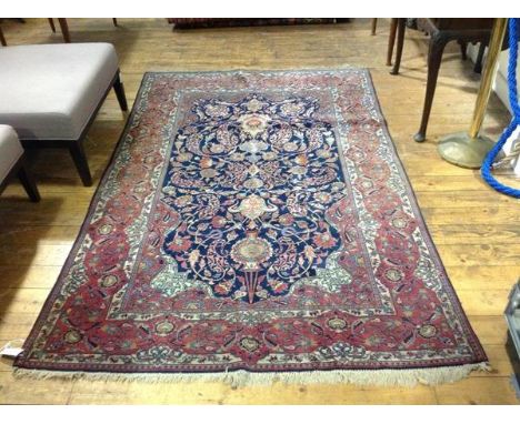 A Hamadan rug, finely knotted, the central panel with hanging lantern design with arabesques and scrolling lotus flowerhead a
