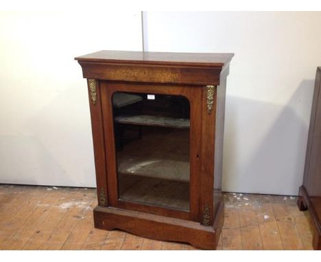 A mid-Victorian gilt-metal mounted inlaid walnut pier cabinet, the rectangular top with moulded edge over a glazed door flank