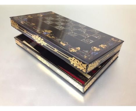 A late 19th century mother-of-pearl inlaid and gilt-painted games box with chess board to the exterior and backgammon board t