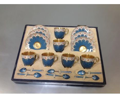A Royal Worcester coffee service for six cased with six enamelled silver coffee spoons, the cups and saucers bearing factory 