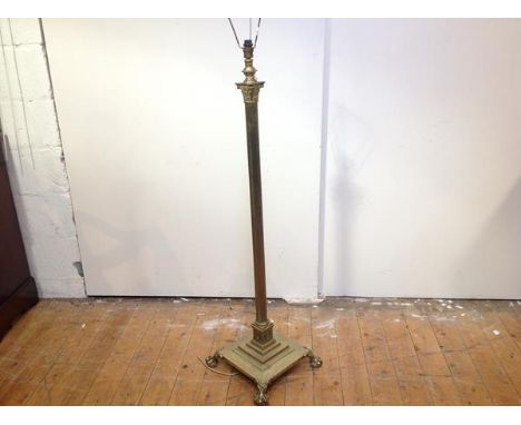A brass Corinthian columnar standard lamp, early 20th century, the fluted column on a stepped square base raised on ball and 