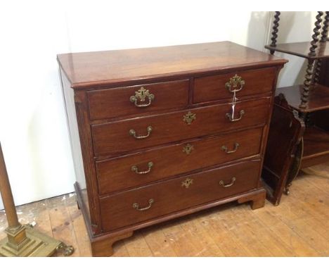 A George III mahogany chest of drawers, the rectangular top with moulded edge over two short and three long graduated drawers