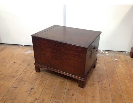 A small George III mahogany chest or coffer, the rectangular hinged top over a conforming case fitted with brass bale carryin