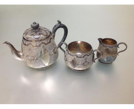 A Victorian silver three piece "bachelor's" tea service, William Edwards, London 1876, each piece with stud and cartouche dec