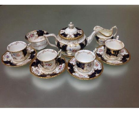 A 19th century Coalport blue Batwing partial tea service, pattern no. Y2665, comprising teapot, cream sugar and four cups and